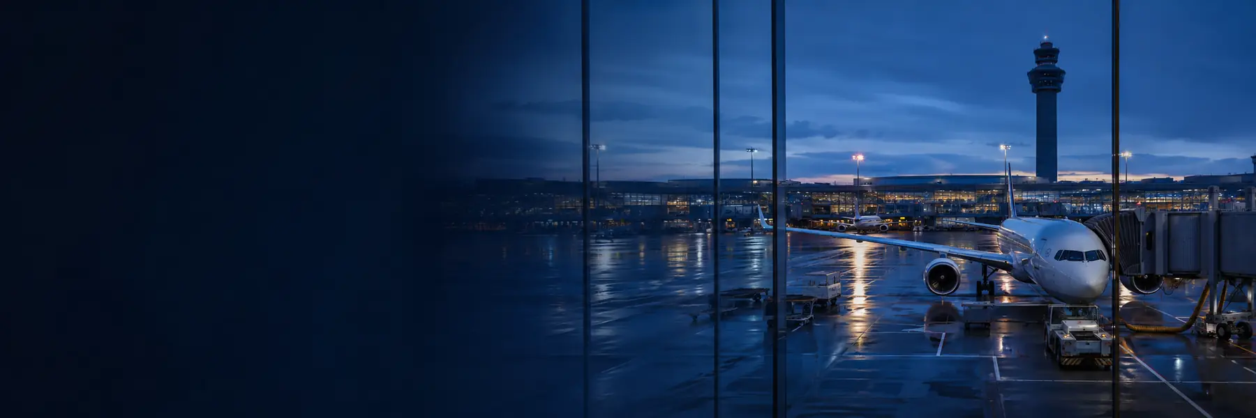 Aircraft and control tower at an airport at dusk